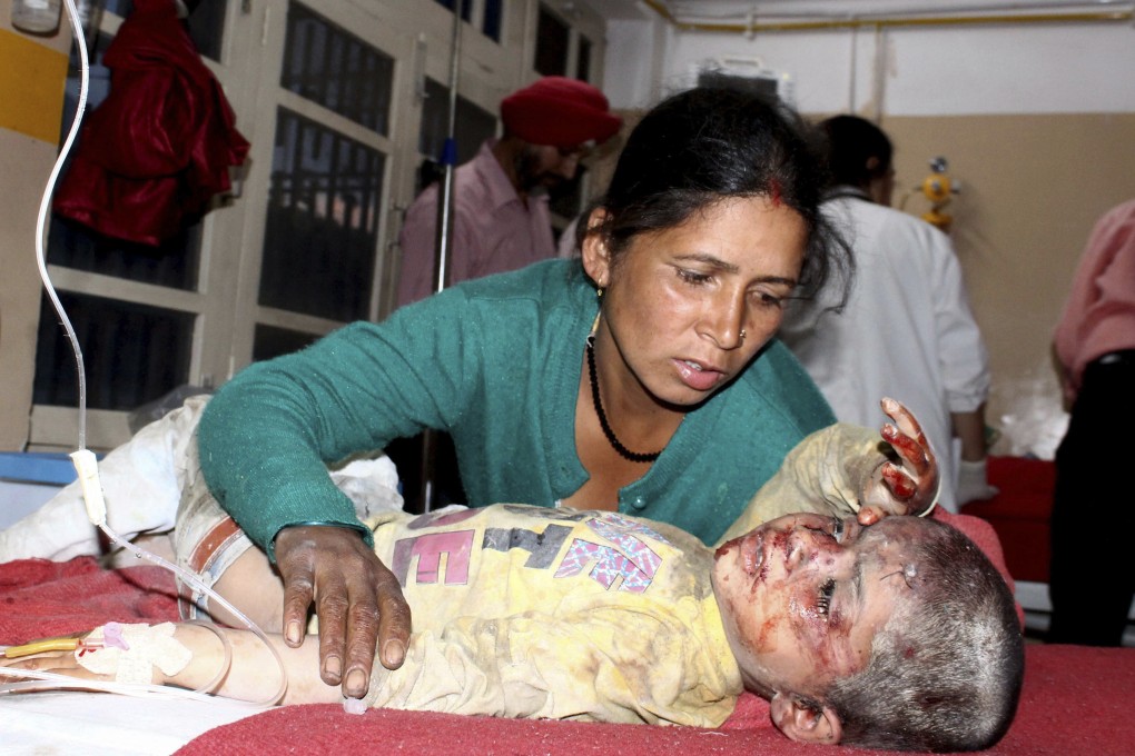 A woman attends to her injured child receiving treatment at a hospital in Kullu, in the northern Indian state of Himachal Pradesh. Photo: AP