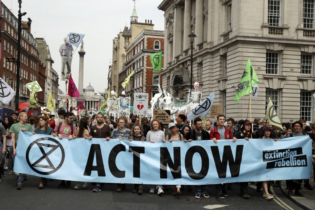 Climate change protesters march along Whitehall toward parliament, in London. Photo: AP Photo