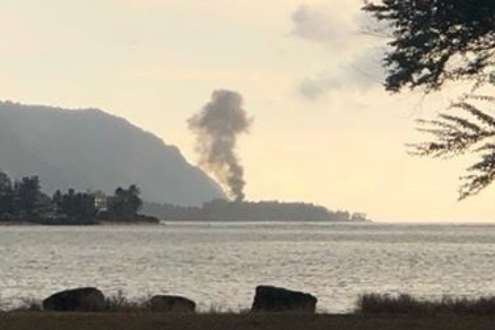 A plume of smoke rises after the crash, seen from Kaiaka Bay Beach Park, in Haleiwa, Hawaii. Photo: Reuters