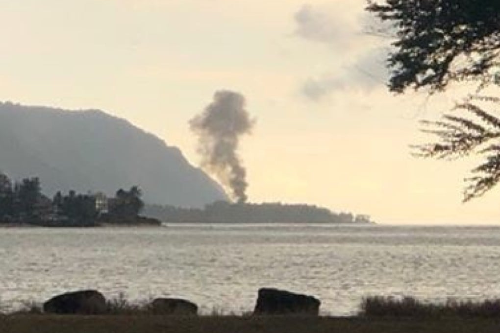A plume of smoke rises after the crash, seen from Kaiaka Bay Beach Park, in Haleiwa, Hawaii. Photo: Reuters