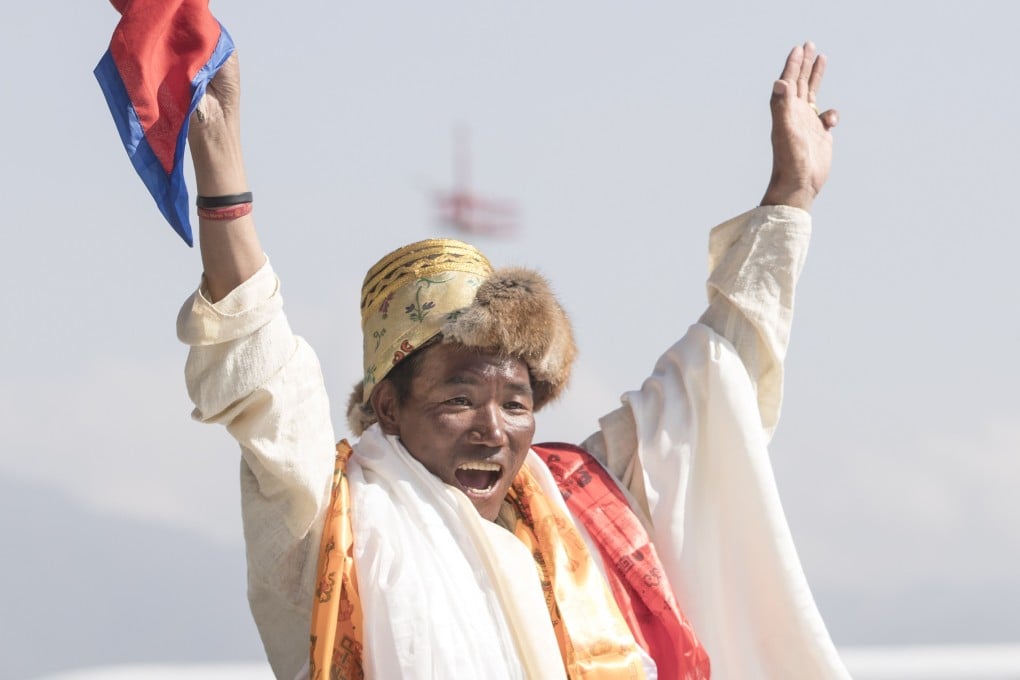 Kami Rita Sherpa celebrates setting a new world record for climbing Mount Everest. Photo: EPA