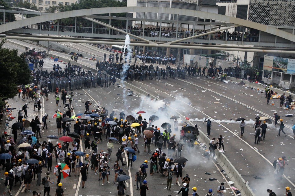 Police officers fire tear gas at anti-extradition bill protesters in Hong Kong on June 12. Photo: K. Y. Cheng