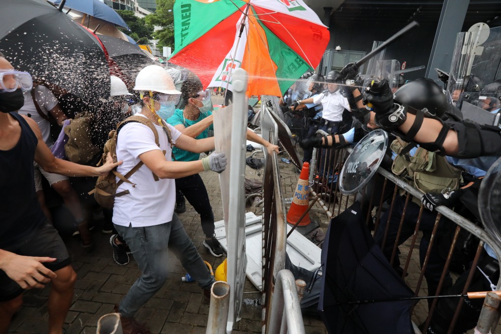 Police officers in anti-riot gear use pepper spray during a clash with anti-extradition bill protesters attempting to charge into Hong Kong’s Legislative Council Complex. Photo: Felix Wong