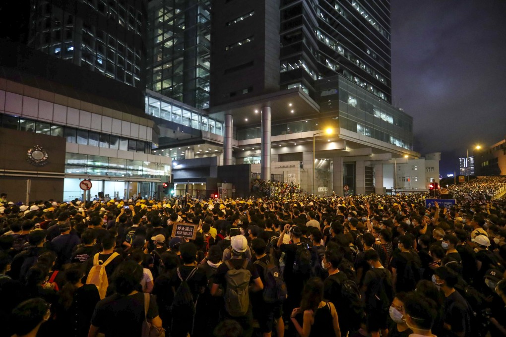 Thousands of protesters surround police headquarters late into Friday night. Photos: Edmond So