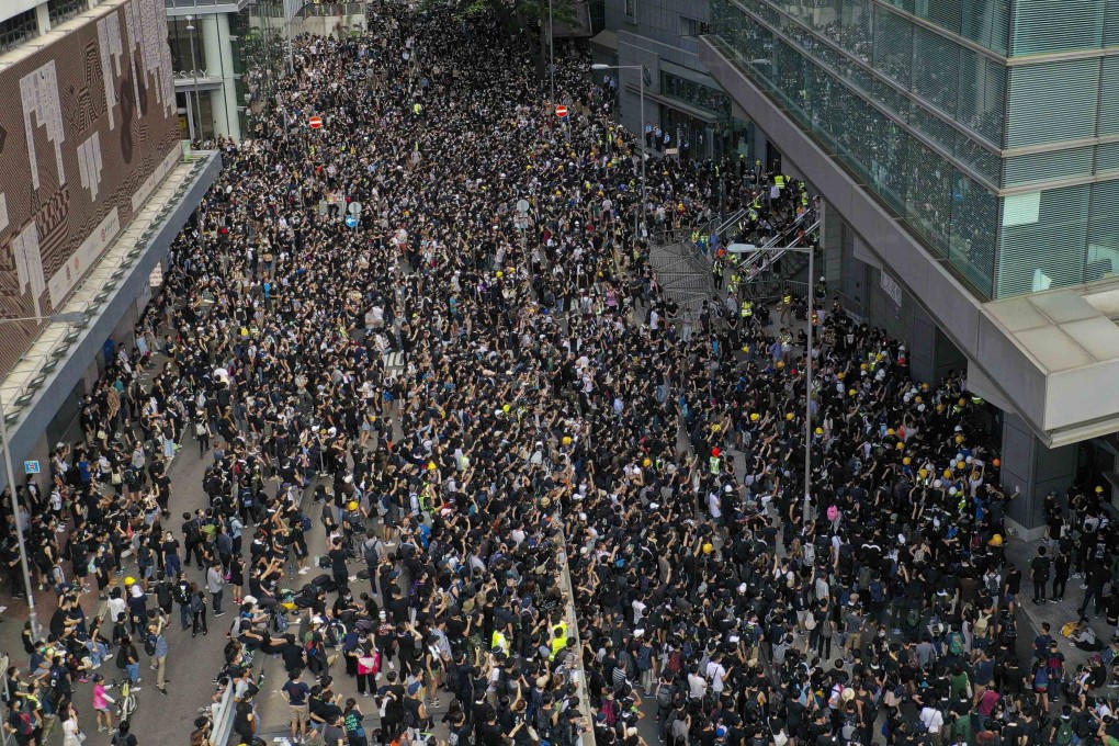 Protesters outside police headquarters in Wan Chai on Friday. Photos: Martin Chan