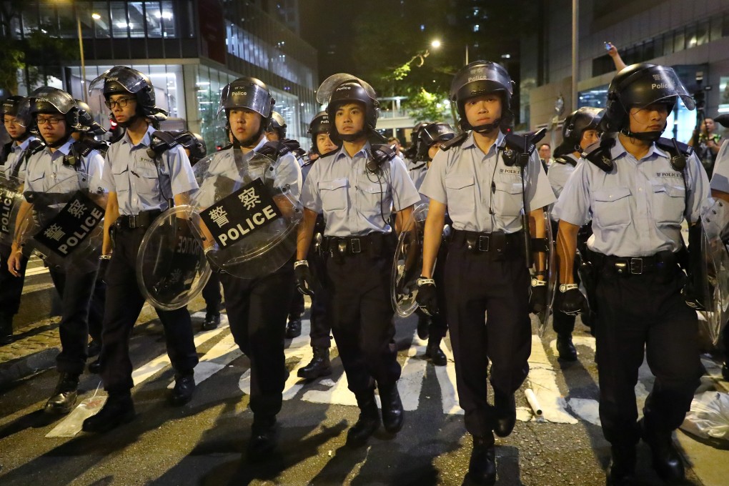 Police officers in anti-riot gear patrolling their headquarters in Wan Chai. Photo: Edmond So