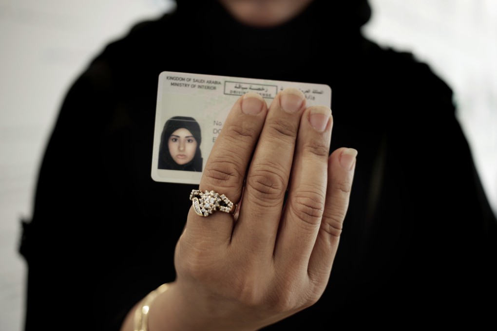 A Saudi woman covering her name on her driving licence. Photo: AP