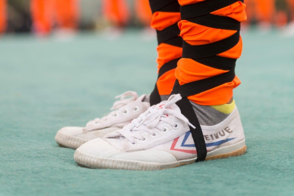 A Shaolin kung fu student wearing Feiyue shoes. The sneakers are making a comeback in China as younger consumers seek out ‘Made in China’ heritage brands. Photo: Alamy