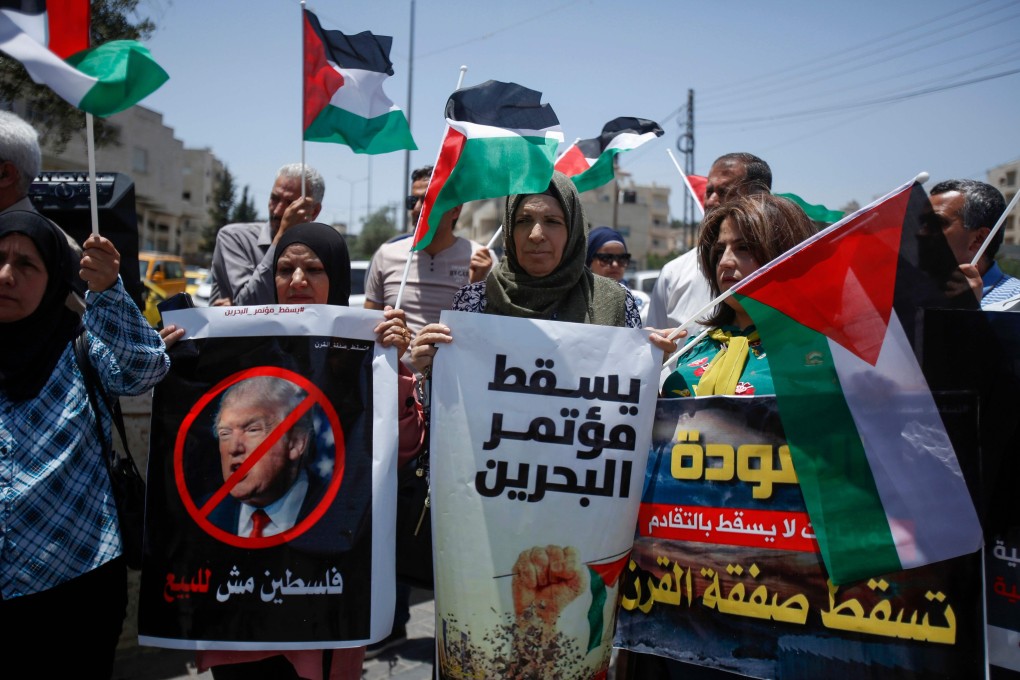 Palestinians hold banners and shout slogans as they rally against the US-led Israeli-Palestinian peace conference in Bahrain. Photo: AFP