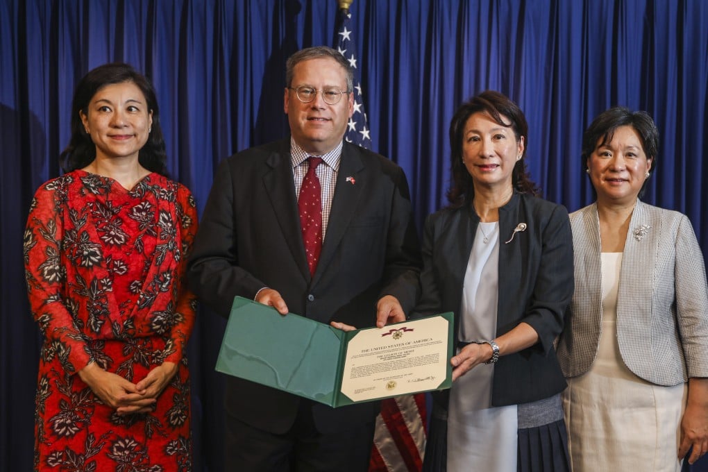 US consul general Kurt Tong presents Mary-Jean Wong with the replica citation certificate. Also pictured are Wong’s sisters Margaret (left) and Christine. Photo: Xiaomei Chen