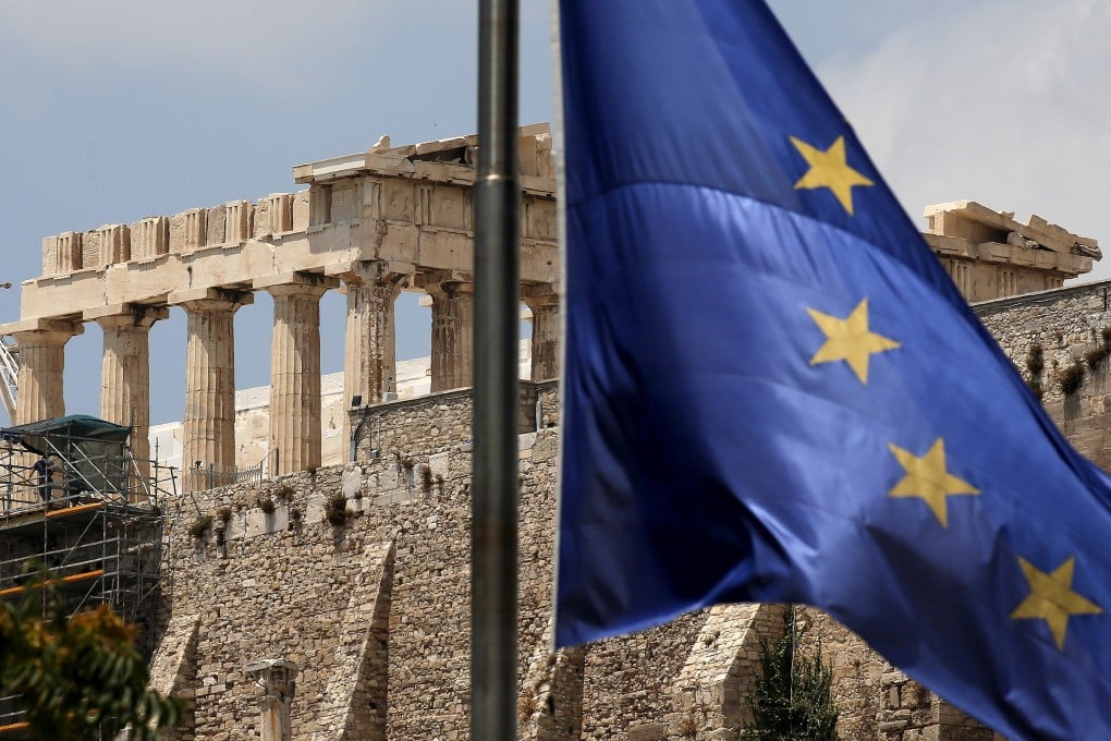 A European Union flag flutters before the temple of Parthenon at the Acropolis hill in Athens. Photo: Reuters