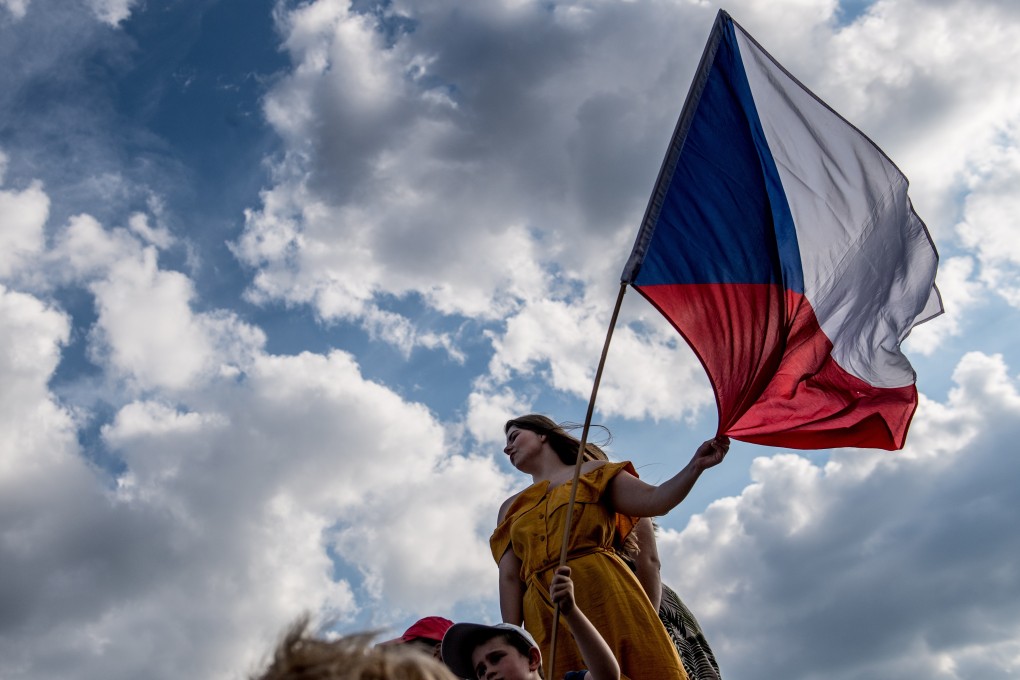 A protester holds Czech flag as she protests against Czech Prime Minister Andrej Babis and new minister of justice. Photo: EPA-EFE