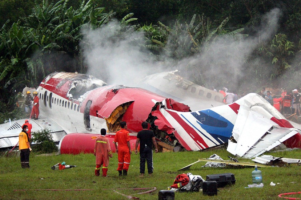 Rescue workers stand next to the wreckage of Thai budget carrier One-To-Go plane in September 2007. Photo: AFP