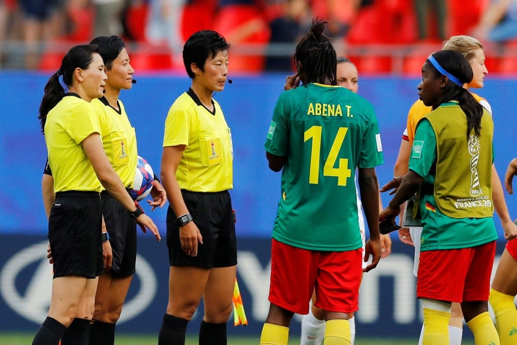 Cameroon's Ninon Abena and teammates remonstrate with referee Qin Liang after the match. Photo: Reuters