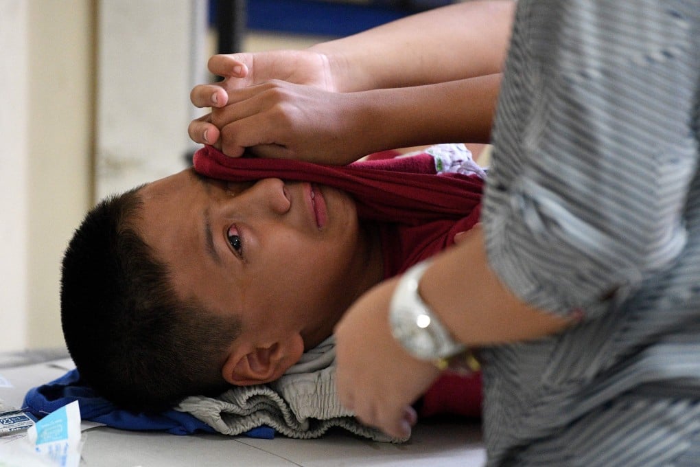 A boy reacts while being circumcised during a mass circumcision at a village health centre in Manila. Photo: AFP