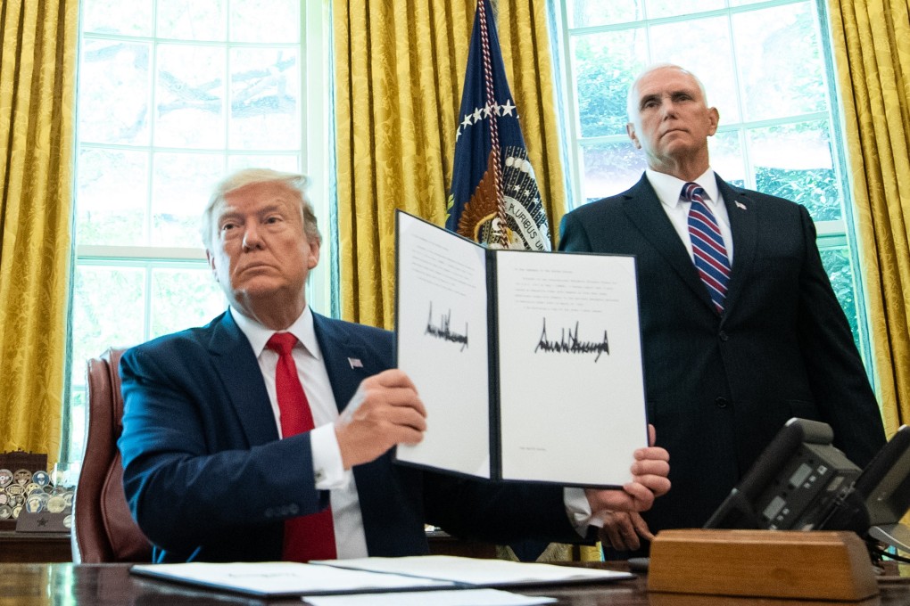 US President Donald Trump holds up a copy of an executive order for additional sanctions against Iran and its leadership, after signing it in the Oval Office. Photo: EPA-EFE