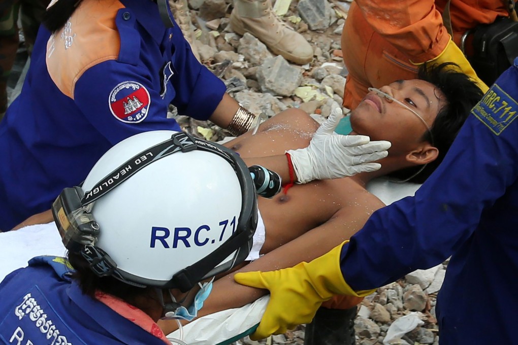 A survivor is carried out of the rubble. Photo: AFP
