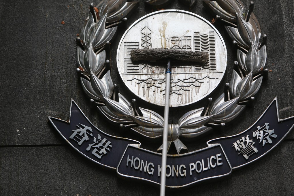 The Hong Kong Police insignia outside their headquarters in Wan Chai is cleaned up, after protesters defaced the building with eggs and graffiti on June 21. Photo: Winson Wong