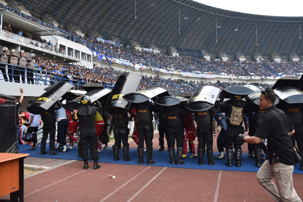 Indonesia riot police stand guard during a match between Persija and Bandung, before which a Persija fan Haringga Sirla was beaten to death. Photo: AFP