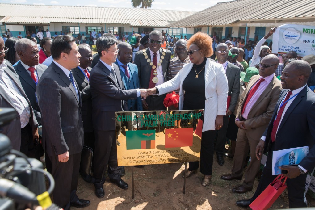 Dora Siliya, Zambia's minister of information, shakes hands with Zhang Maoyu, vice-chairman of China International Development Cooperation Agency, during the completion ceremony of a China-funded TV project in Chongwe. Photo: Xinhua