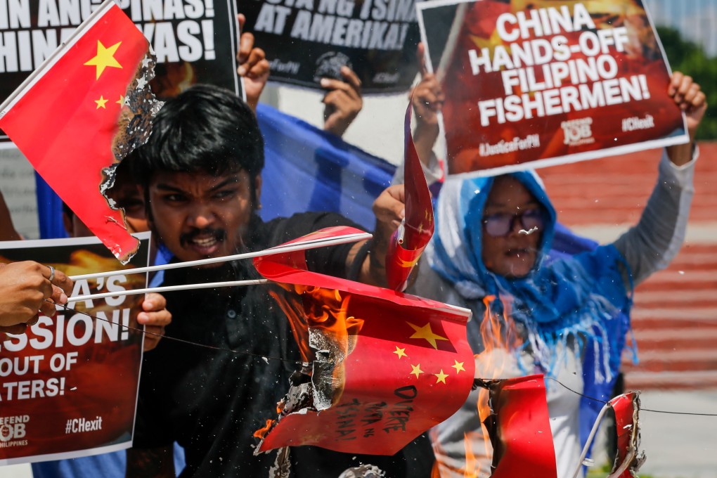 Activists in Manila burn paper Chinese flags during a protest on June 18 against the alleged sinking of a fishing boat by a Chinese vessel. Photo: EPA-EFE