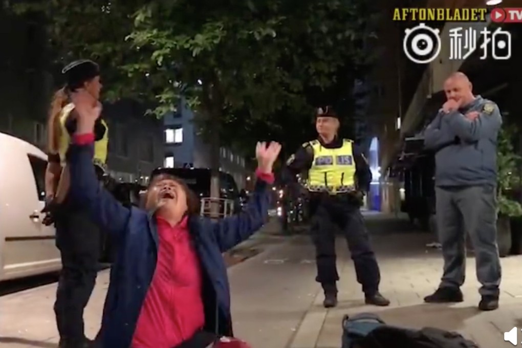 A Chinese tourist drops to the ground outside a hotel in Stockholm during an incident in September that prompted 11 critical statements from the embassy. Photo: Handout