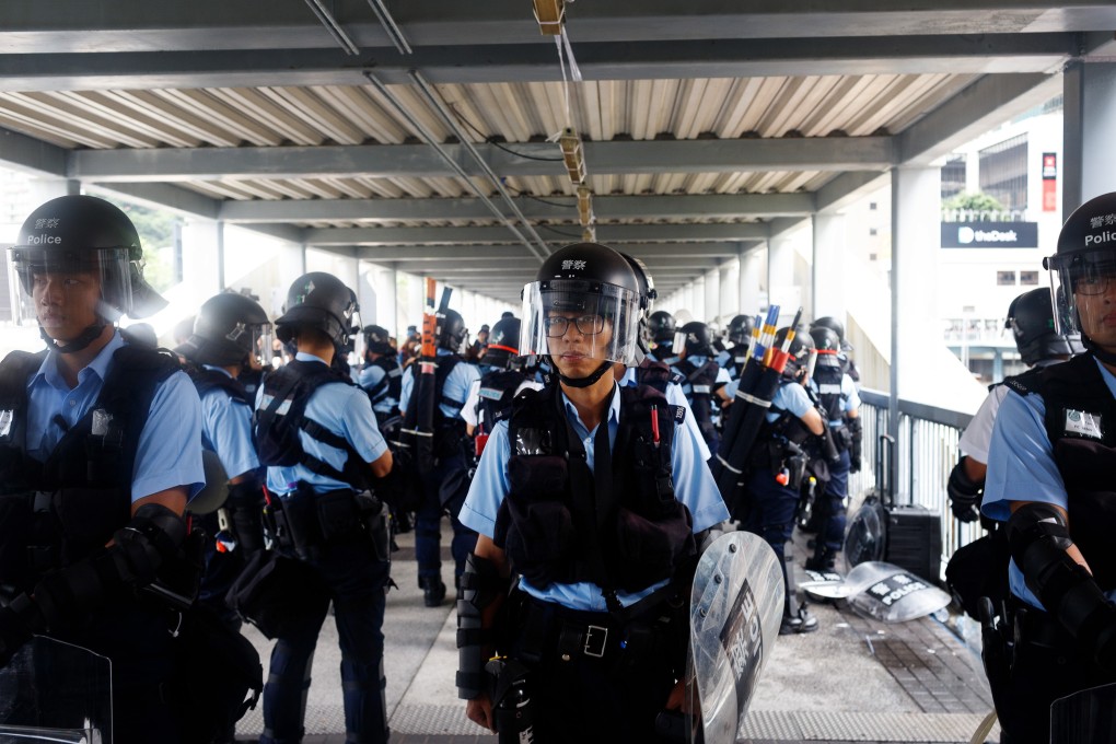 Police stand guard on a footbridge leading to the Legislative Council on June 13, a day after violent clashes over the extradition bill. Photo: Bloomberg