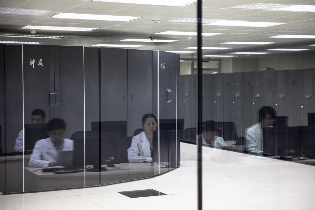 Employees are reflected on glass as they work in front of supercomputers at The National Supercomputer Center in Jinan, Shandong province, China, 17 October 2018. Photo: EPA-EFE