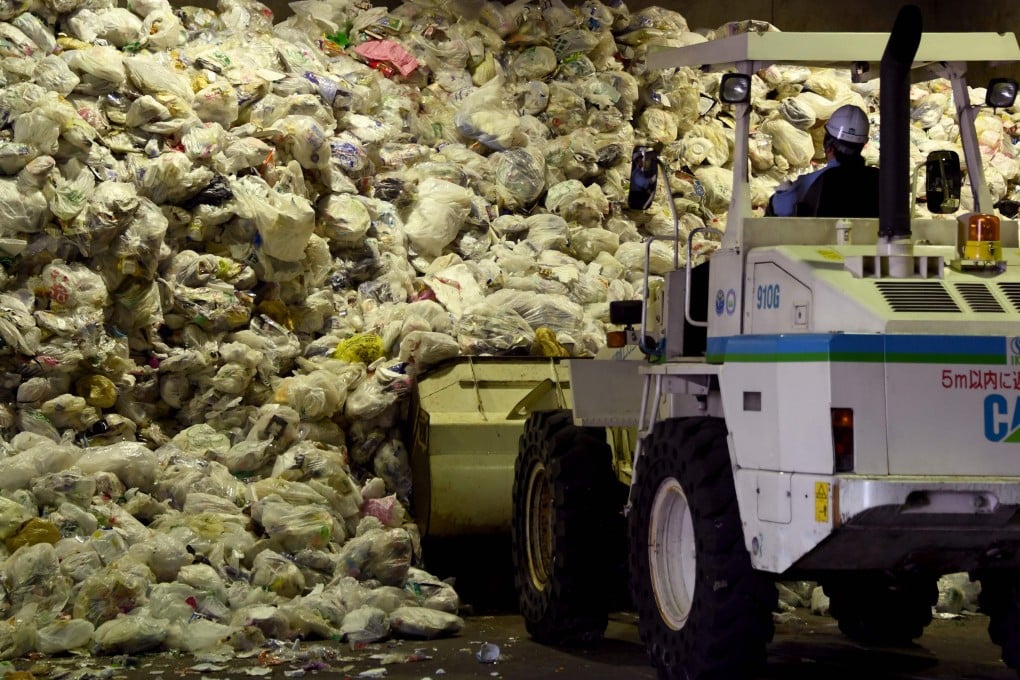 A loader moves plastic recyclable resources onto a conveyor belt at Ichikawa Kankyo Engineering recycle centre in Narashino. Photo: AFP