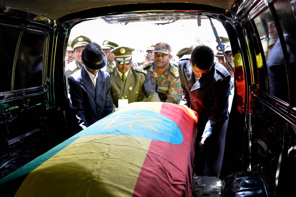 Members of the army carry one of the coffins covered with the Ethiopian national flag. Photo: AFP