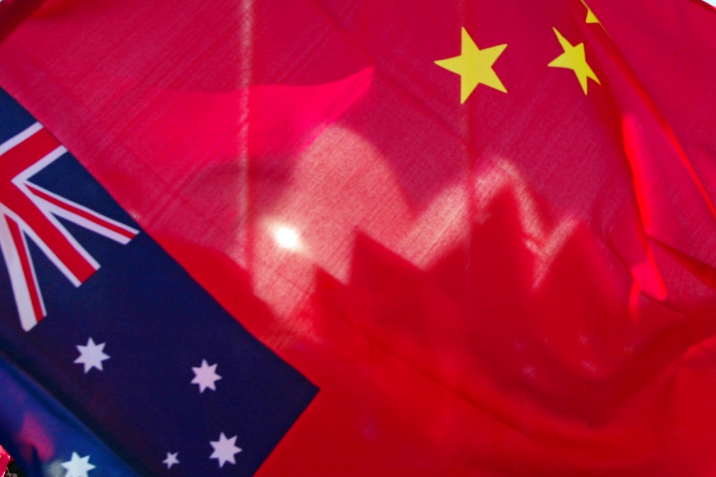 Sydney Opera House seen through a Chinese flag, with an Australian flag in the foreground. Photo: AFP