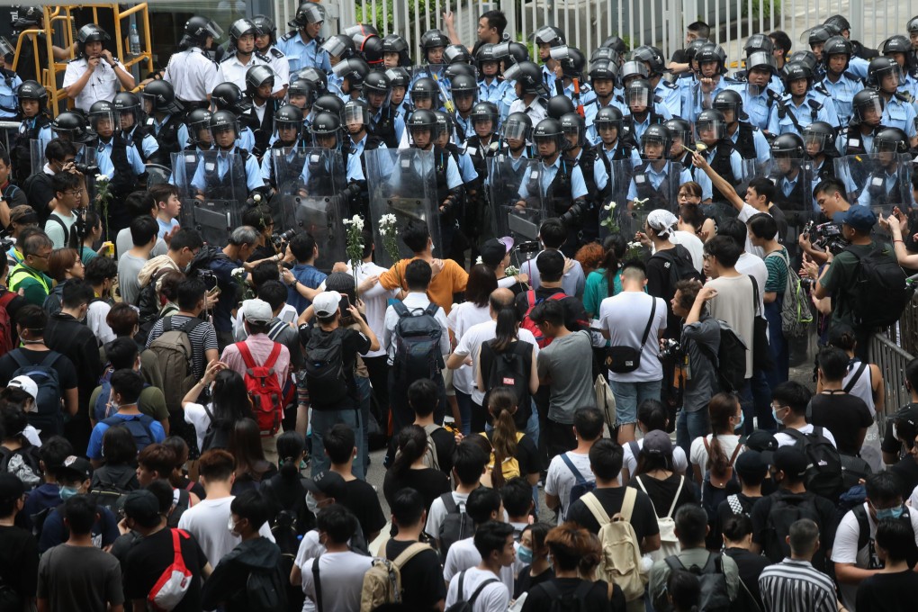 Police officers in riot gear and anti-extradition-bill demonstrators stand toe to toe near the Legislative Council. Photo: Dickson Lee