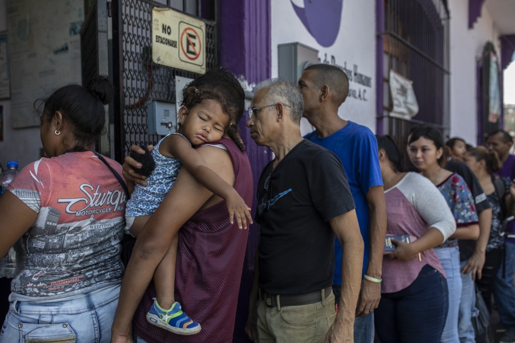 Refugee and asylum seekers stand in line to enter a human rights centre in Tapachula, Chiapas state, Mexico, on June 18. The new show of force on the border is meant to stem the stream of migrants escaping violence and poverty in Central America, a move made to appease President Donald Trump after he threatened to impose tariffs on Mexican imports to punish the country for failing to control the masses trying to make their way to the US. Photo: Bloomberg