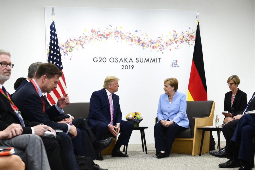 US President Donald Trump with Germany’s Chancellor Angela Merkel at the G20 summit in Osaka on Friday. Photo: AFP