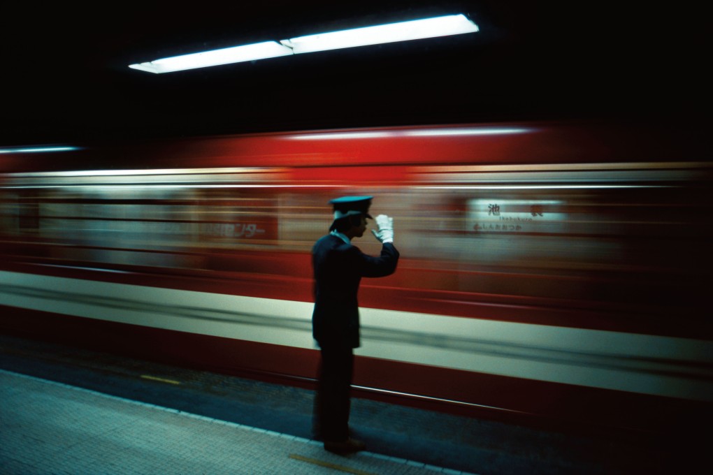Platform conductor, Ikebukuro Station, Tokyo, 1976. Photo: Greg Girard