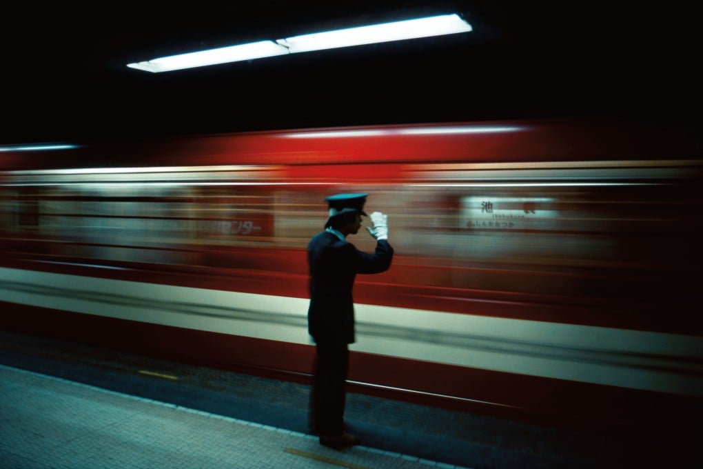 Platform conductor, Ikebukuro Station, Tokyo, 1976. Photo: Greg Girard
