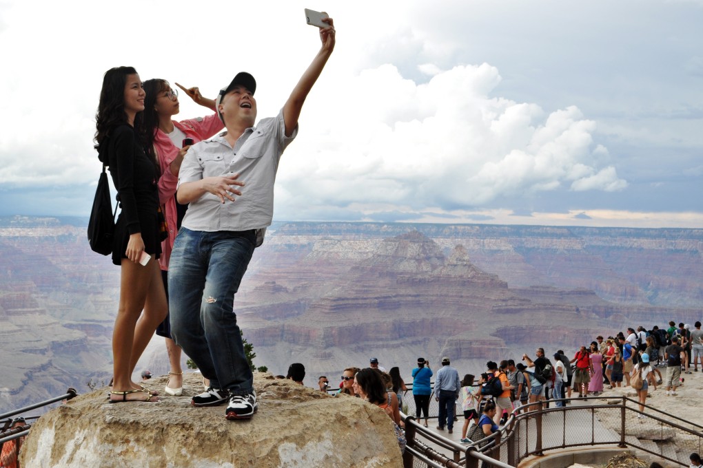 Tourists taking a selfie at America’s Grand Canyon, where a number of people have fallen to their deaths doing the same. Photo: AP