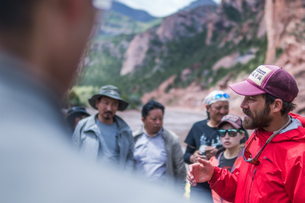 Travis Winn addresses his team during a river trip, but the rafting is only part of his wider goal to save Chinese rivers. Photo: Wang Heng