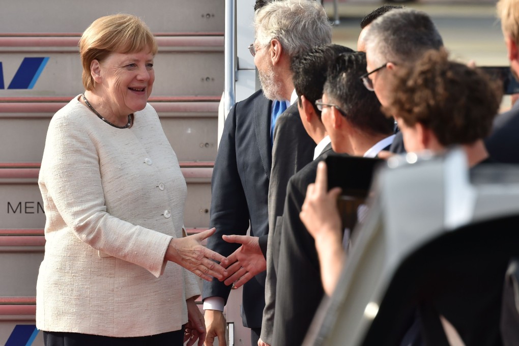 German Chancellor Angela Merkel is greeted by well-wishers upon her arrival at Kansai airport in Osaka prefecture, Japan, on Friday. Photo: AFP