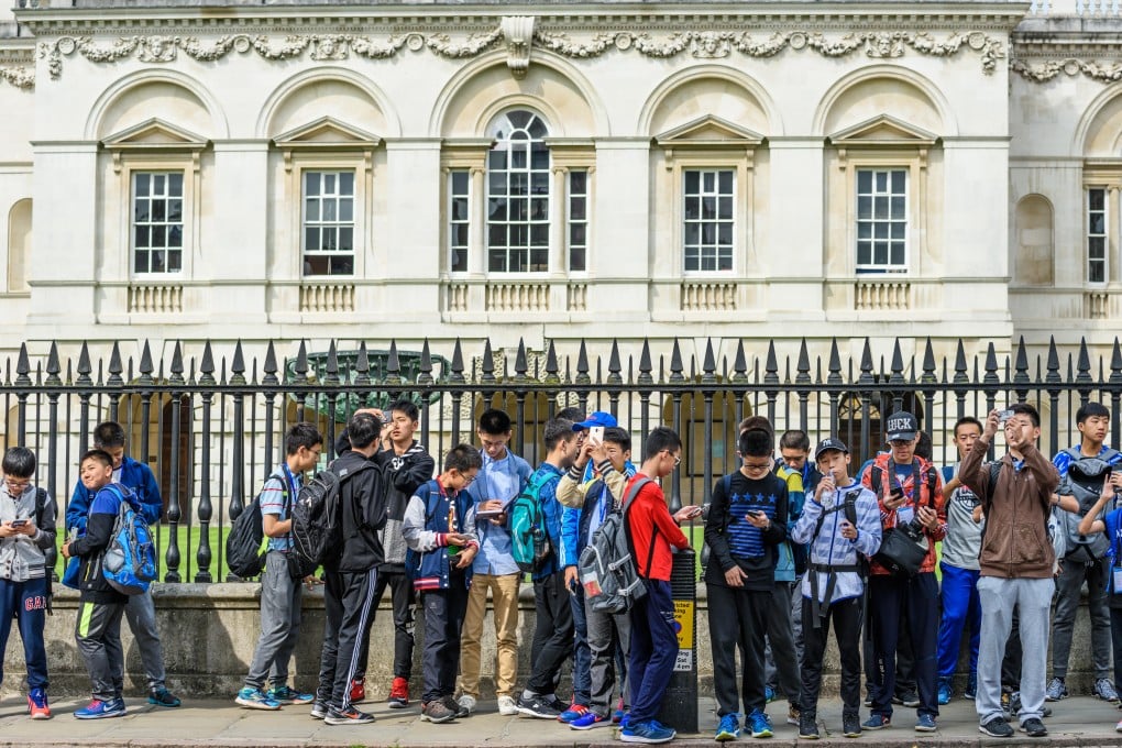 A group of young Chinese students tour the University of Cambridge in England. Photo: Alamy