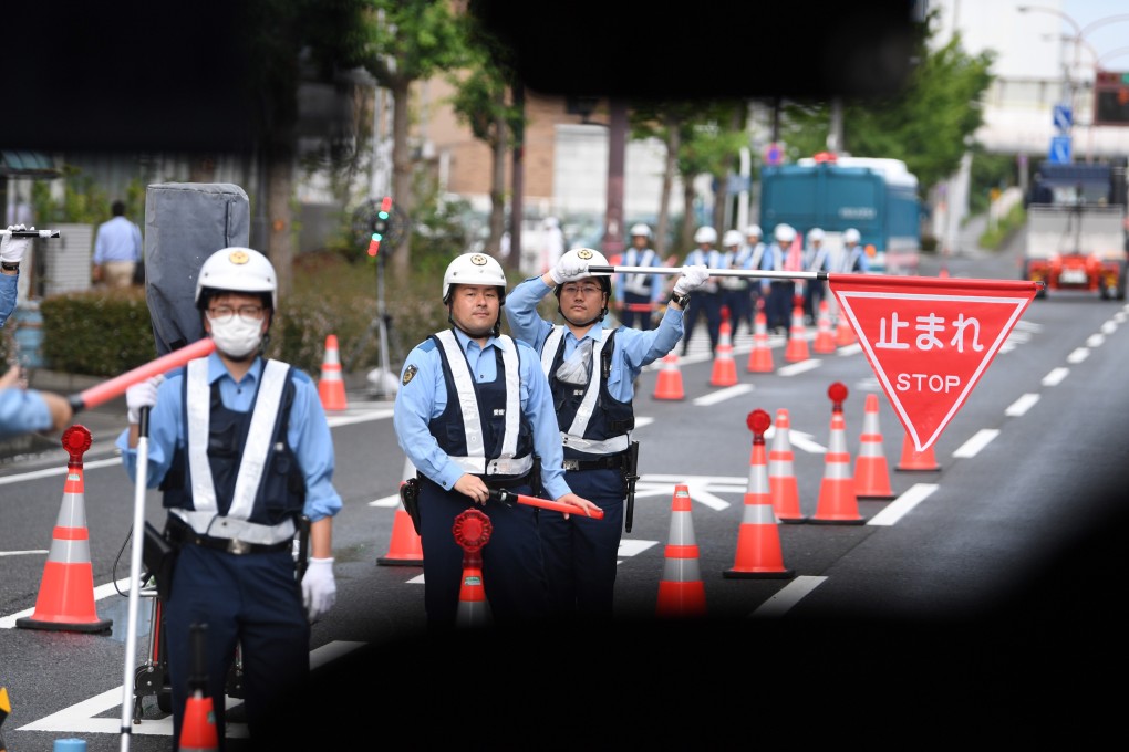 Security stops a media bus at a checkpoint near the G20 summit in Osaka. Photo: EPA