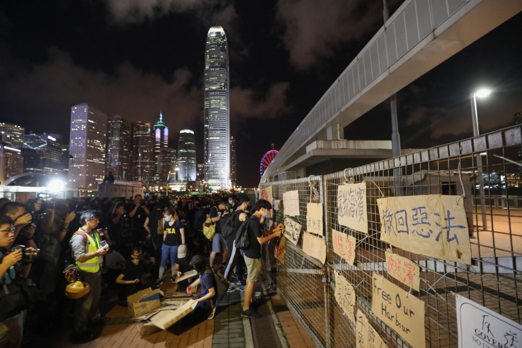 Protesters leave signs on the fence of the restricted site. Photo: Dickson Lee