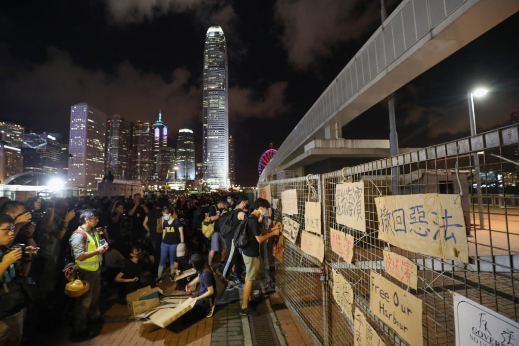 Protesters leave signs on the fence of the restricted site. Photo: Dickson Lee