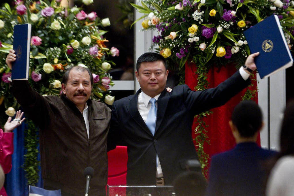 Nicaraguan President Daniel Ortega and Chinese businessman Wang Jing hold up a concession agreement for the construction of the Nicaragua Canal. Photo: AP