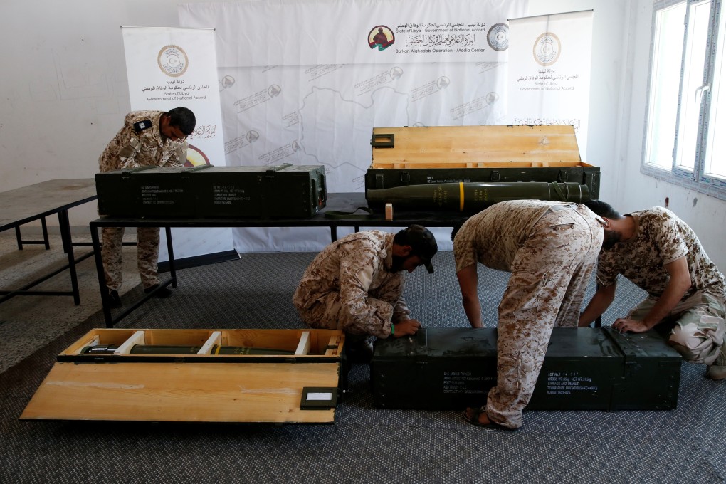 Members of forces allied to Libya's internationally recognized government check the weapons, which were confiscated from eastern forces led by Khalifa Hiftar in Gharyan. Photo: Reuters