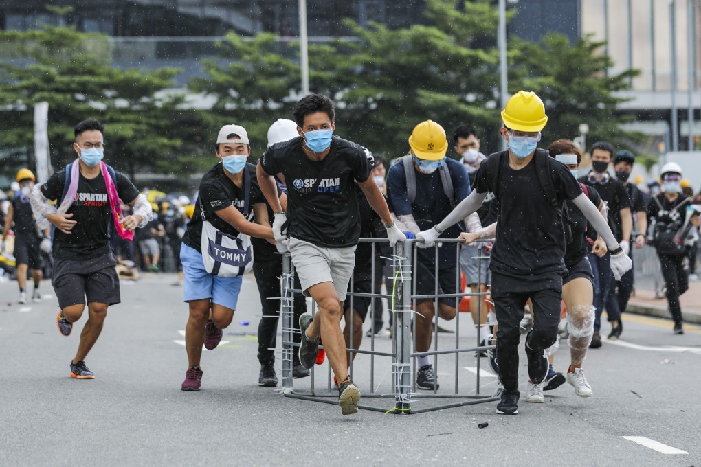 Protesters gather bars and barricades on Harcourt Road as they march against the extradition bill on the 22nd anniversary of Hong Kong's handover from Britain to China. Photo: Sam Tsang
