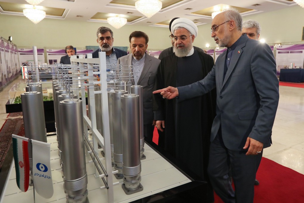 Iranian President Hassan Rowhani (centre) inspects equipment on National Nuclear Technology Day in Tehran. Photo: EPA