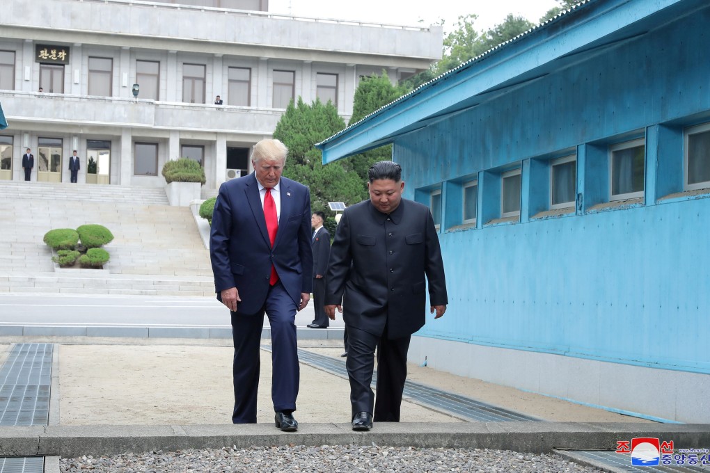 US President Donald Trump and North Korean leader Kim Jong-un cross over a military demarcation line at the demilitarised zone (DMZ) separating the two Koreas. Photo KCNA via Reuters