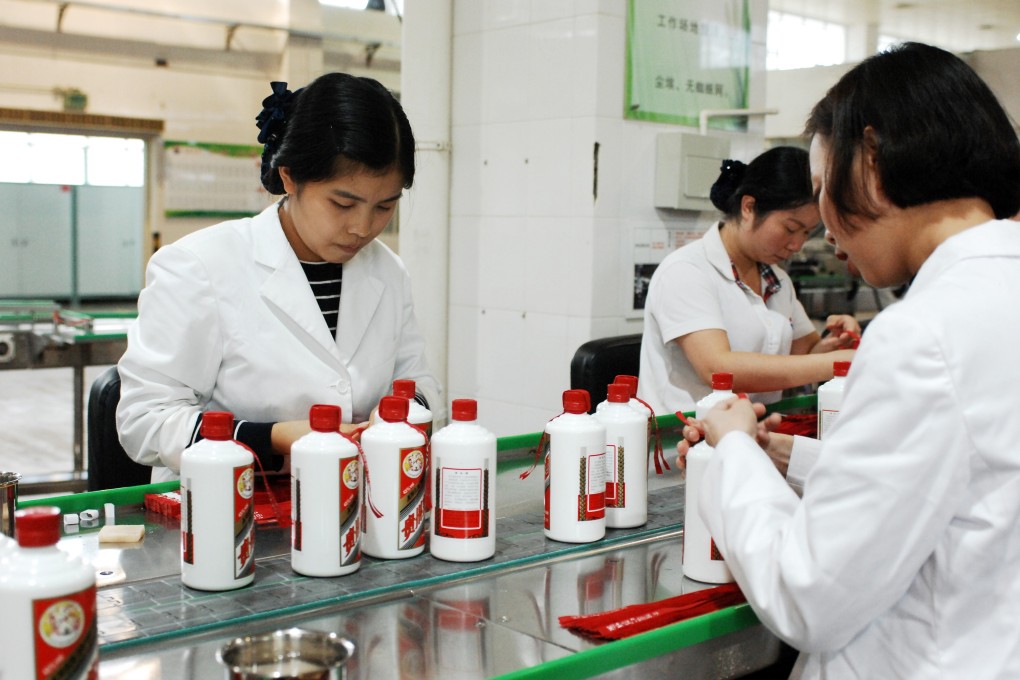 Workers package bottles of liquor at a workshop of Kweichow Moutai in the city of Renhuai in southwest China's Guizhou Province on October 23, 2018. Photo: Xinhua