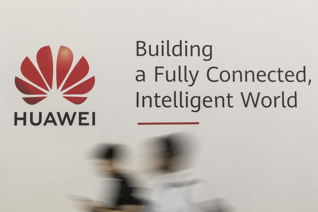 Attendees walk past a sign for Huawei Technologies at the MWC Shanghai 2019 trade show on June 27. Photo: Bloomberg